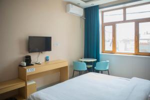TV a/nebo společenská místnost v ubytování Hongge Hotel - Harbin Taiping Airport