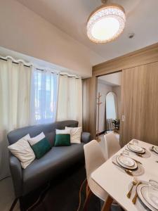 a living room with a couch and a table at 2BR Solana Suite near MOA PICC NAIA in Manila