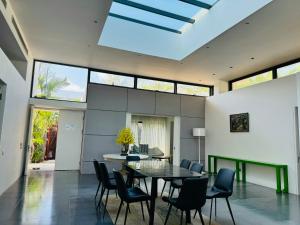 a dining room with a table and chairs at Premium BEACHFRONT VILLA 5 BEDROOMS 1000M2 SANCTUARY HO TRAM RESORT ll BBQ in Thuận Biên