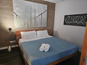 a bedroom with a bed with two towels on it at Bellio in Sobe in Miami Beach +73 photos