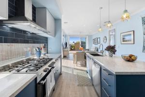 a kitchen with blue cabinets and a counter top at Serenity Nook Cottage in Point Lonsdale