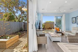 a living room with a couch and a table at Serenity Nook Cottage in Point Lonsdale