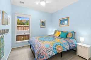 a bedroom with a bed and a window at Serenity Nook Cottage in Point Lonsdale