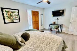 a bedroom with a bed and a television in it at Apartment A, Restful,Cozy, close Sunland Park Mall in El Paso