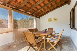 a dining room with a wooden table and chairs at Holiday house with a parking space Milna, Brac - 20140 in Milna