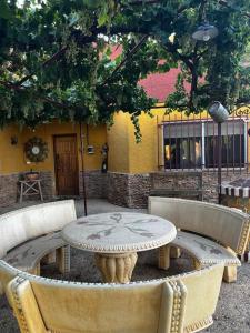 a table and chairs in front of a building at Villa Rural El doncel in Hellín