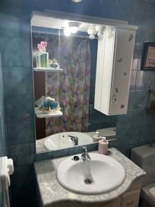 a bathroom with a sink and a mirror at Villa Rural El doncel in Hellín