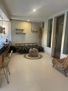 a living room with a couch and a table and chairs at Base Villa in Canggu