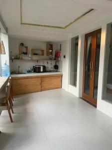 a kitchen with a large white tile floor at Base Villa in Canggu +16 photos
