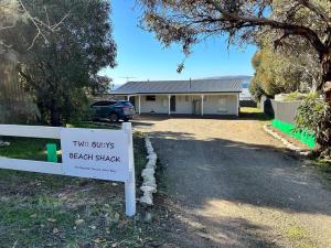 a house with a sign in front of a driveway at Two Buoys Emu Bay in Emu Bay +7 photos