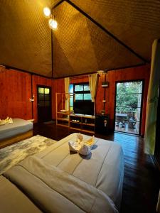a bedroom with a large bed and a living room at Ingphu Mountainview Khao Yai in Ban Khan Takhian +105 photos