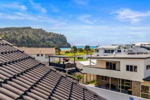 a view from the roof of a building with houses at The Dunes - Whangamata Holiday Apartment in Whangamata