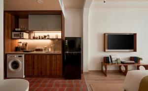 a kitchen with a washer and dryer in a room at The Urban Resort by CIRCADIAN in Ho Chi Minh City