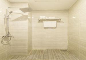 a bathroom with a shower with a glass door at Trang Ngan Hotel by THG in Danang