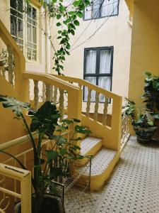 a stairway in a building with a plant at Azalea Apartment in Hanoi +65 photos