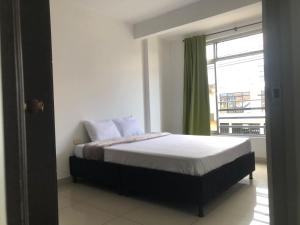 a bedroom with a bed with a large window at Casa privada en Montenegro Quindio in Montenegro