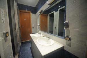 a bathroom with two sinks and a mirror at Hostel Beauty in Rome