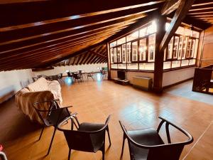 a large room with chairs and a stage in a building at Albergue Pinares - La Casona de Revenga in Regumiel de la Sierra