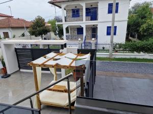 a table on a patio in front of a house at Aeonian Luxury Suites Asprovalta, Adults Only & Kids 12 Plus in Asprovalta