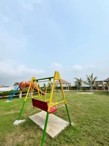 a playground with a slide and a giraffe at Sunview Resort in Mandarmoni