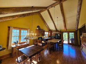 a kitchen with a dining room and a dining table at Chanticleer Cabins in Sturgeon Bay