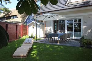 a patio with a table and an umbrella at In den Katen in Wieck