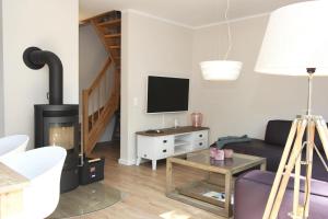 a living room with a couch and a fireplace at In den Katen in Wieck