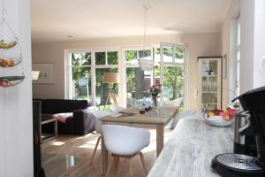 a living room with a table and a couch at In den Katen in Wieck