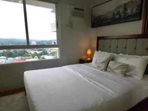 Ένα ή περισσότερα κρεβάτια σε δωμάτιο στο TJ Urban Living - Studio Unit at Mesatierra Davao +16 φωτογραφίες