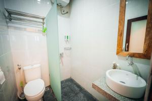 a bathroom with a toilet and a sink and a mirror at Villa Umah Seminyak in Seminyak +23 photos
