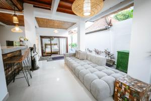 a living room with a long couch in the middle at Villa Umah Seminyak in Seminyak