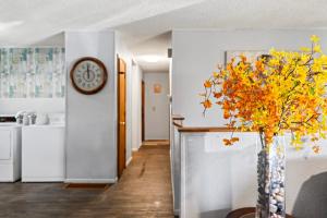 a kitchen with a vase with yellow flowers in it at ShaligoHomes Sunset Room On 6th Ave in Anchorage