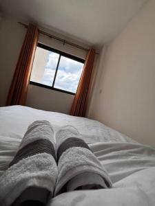 Postel nebo postele na pokoji v ubytování Luxore Residence, Syokimau + 1 fotografie