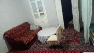 a small room with a bed and a door at Private Courtyard Cozy House in Tashkent