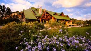 a large wooden building with flowers in front of it at Disney's Wilderness Lodge in Orlando