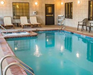a large swimming pool with chairs in a hotel room at Sleep Inn & Suites at Six Flags in San Antonio