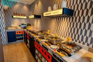 a kitchen with a buffet with food on it at Hampton By Hilton Santiago Las Condes in Santiago