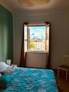 a bedroom with a bed and a large window at CalaMia in Palermo +27 photos