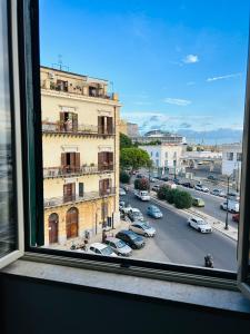 a view of a city street from a window at CalaMia in Palermo