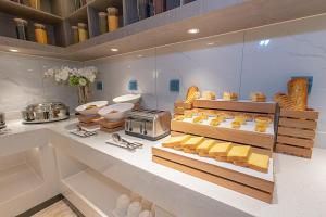 a room with a counter with a bunch of food at Echarm Hotel Panzhihua Hubin Road in Panzhihua