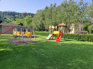 a park with a playground with a slide at Haus Bergblick in Faak am See