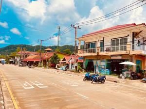a motorcycle parked on the side of a street at Lanta Grand House in Ko Lanta