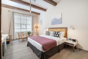 a hotel room with a bed and a table at Beach Walk Boutique Jumeirah in Dubai