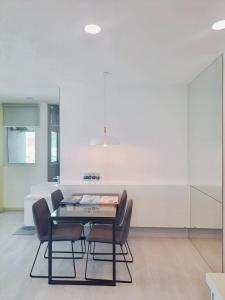 a dining room with a black table and chairs at 23th 2BR1B Straits Garden Suites Georgetown Jelutong in Jelutong