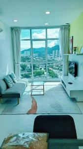 a living room with a couch and a large window at 23th 2BR1B Straits Garden Suites Georgetown Jelutong in Jelutong