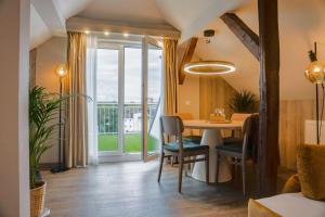 a dining room with a table and a large window at Liebig-Hotel in Gießen