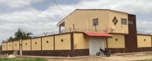 a building with a motorcycle parked in front of it at Seaside Villa Sleeps 2 with Ocean Views in Siendou