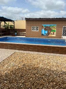 a large swimming pool next to a building at Seaside Villa Sleeps 2 with Ocean Views in Siendou