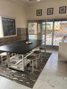 a dining room with a black table and chairs at Sendou Cabano Villa Sleeps 6 with Parking in Siendou