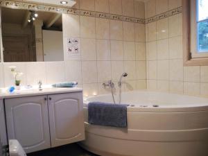 a bathroom with a tub and a sink at Hagebutte - Baabe in Baabe